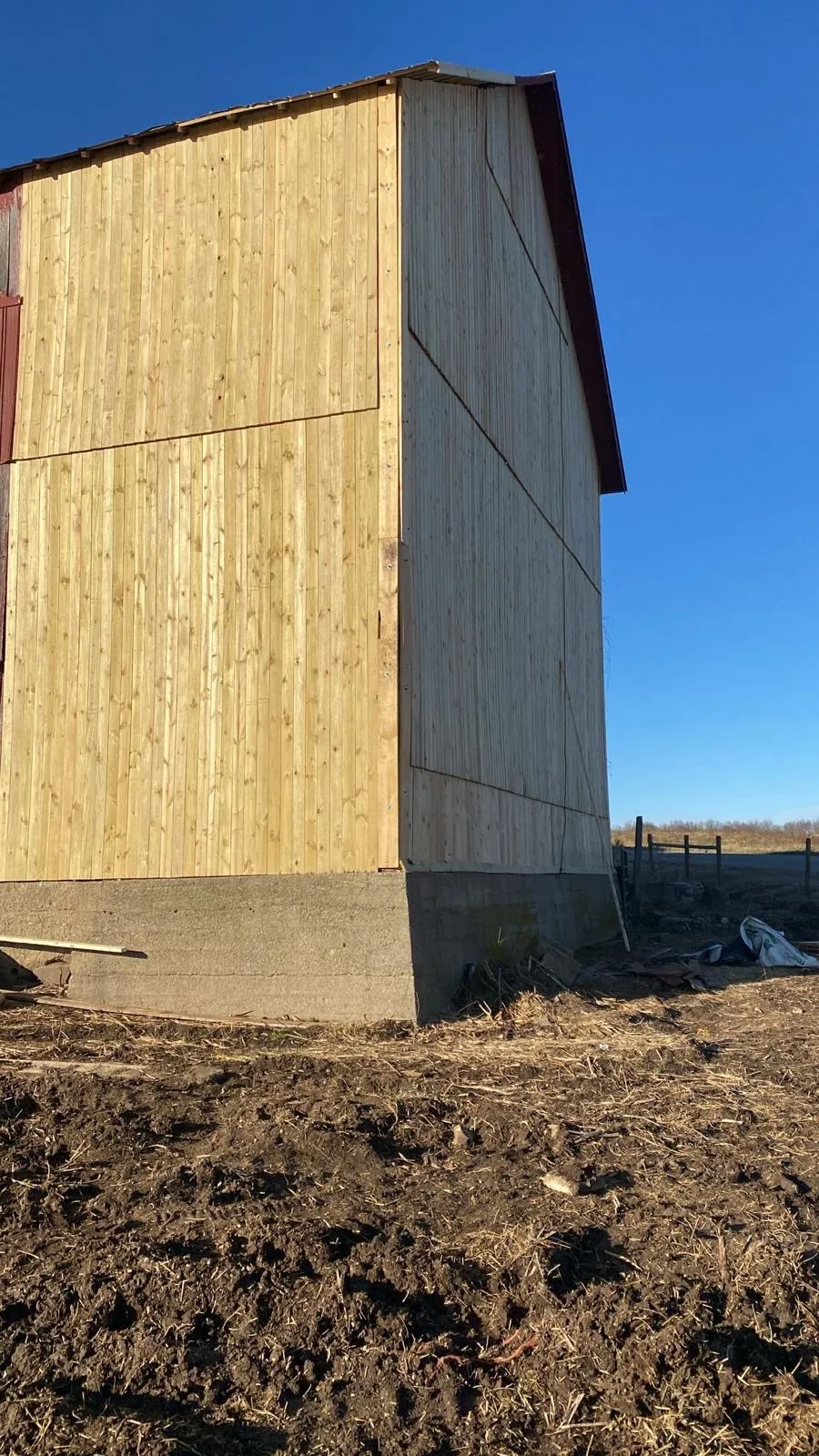 Barn wall rebuilt with new wood siding