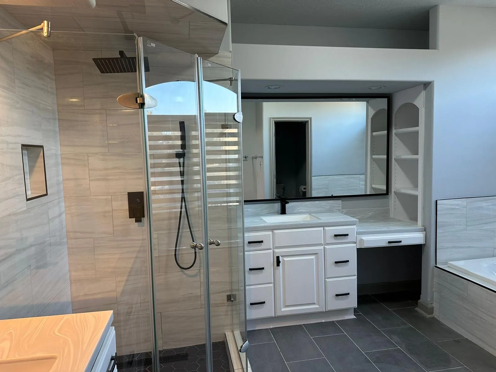 Bathroom remodel in progress with vanity and tile work underway