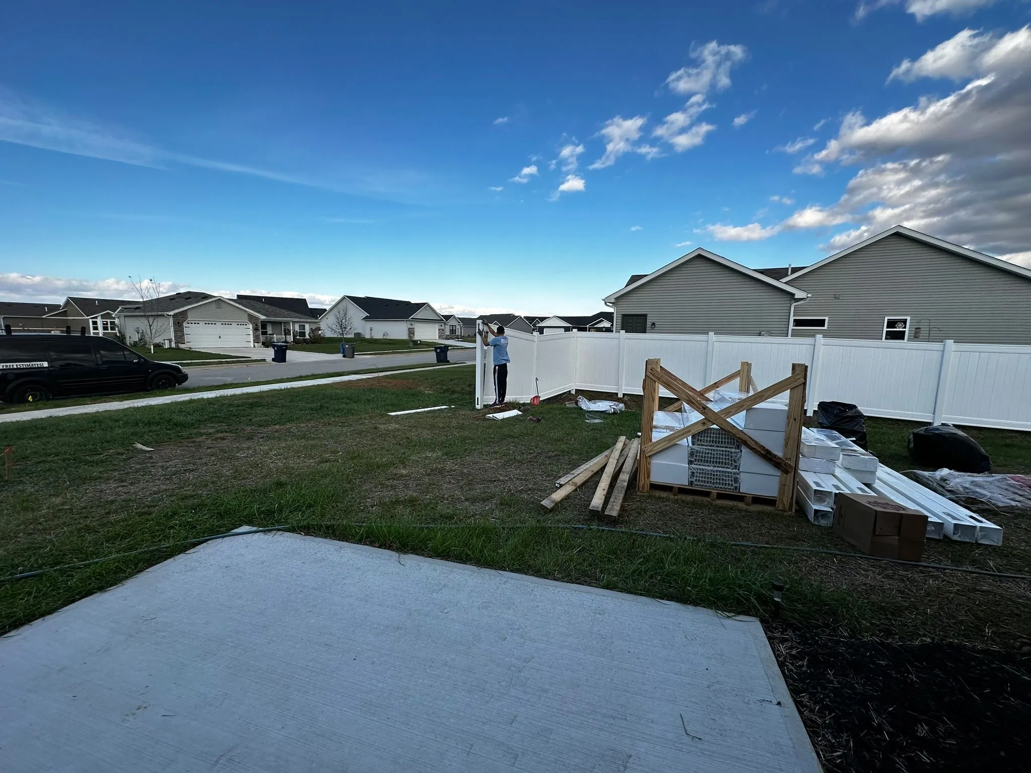 Cedar fence mid-installation with posts set