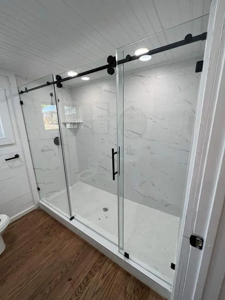 Walk-in shower with sliding glass door built by TG Renovates
